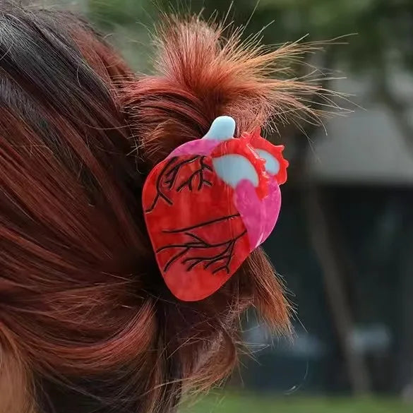 Four different hair accessories styled in a person's hair with various text and designs.